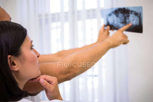 Dentists discussing over dental x-ray report in clinic — Stock Photo