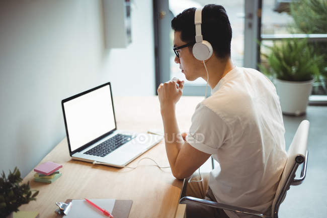 Business executive working on laptop in office — Stock Photo