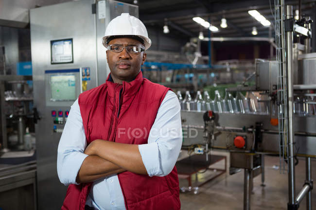 Portrait of confident male employee standing in manufacturing industry — Stock Photo