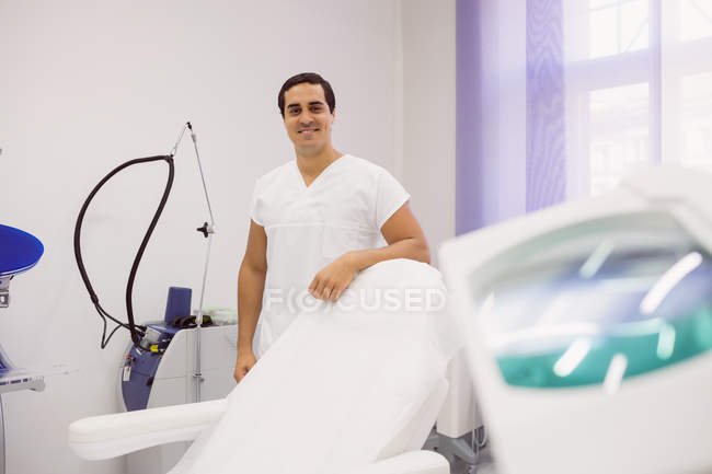 Front view of mid adult dermatologist standing in clinic — Stock Photo