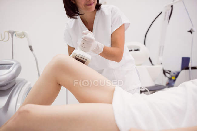Mujer recibiendo tratamiento cosmético contra la celulitis en la clínica - foto de stock