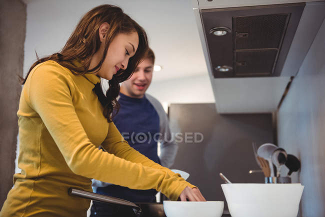 Couple using digital tablet while preparing cookies in kitchen at home — Stock Photo