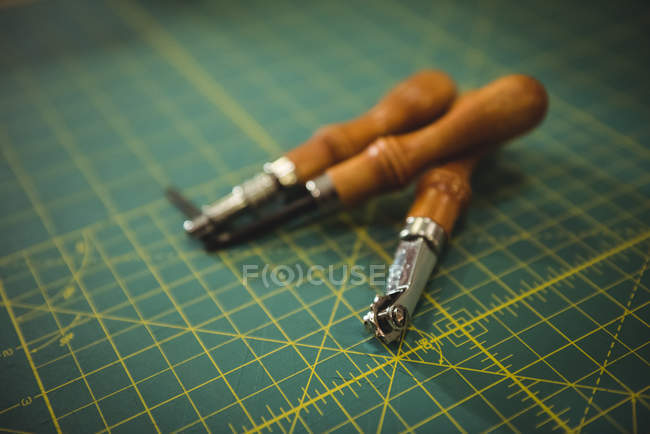 Work tools on patterned table in workshop — Stock Photo