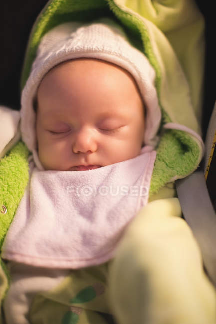 Close-up of cute newborn baby sleeping in stroller at home — Stock Photo