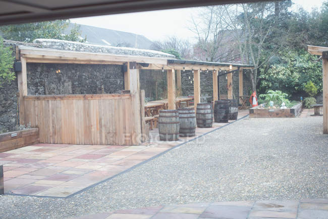 Yard with wooden barrels of modern outdoor country style cafe — Stock Photo