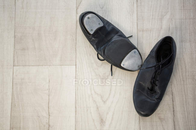 Close-up of tap shoes on wooden floor — Stock Photo