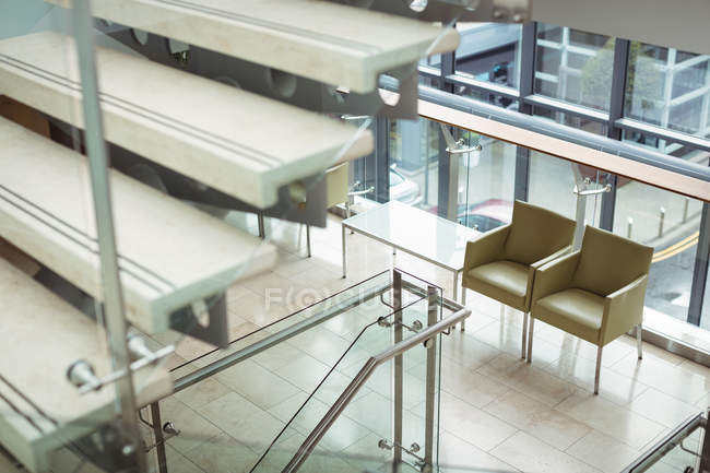 Empty chairs near staircase in office building — Stock Photo