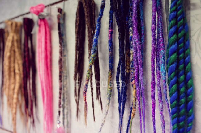 Assorted colorful artificial dreadlocks in shop — Stock Photo