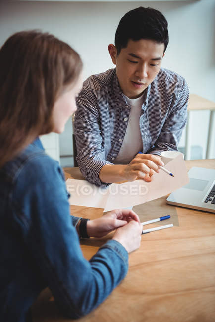 Business executives discussing over document in office — Stock Photo
