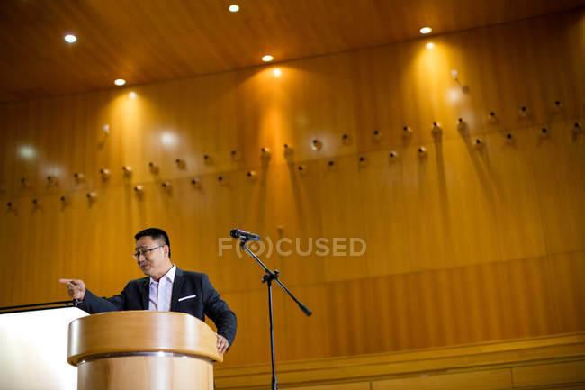 Uomo business executive tenendo un discorso al centro congressi — Foto stock