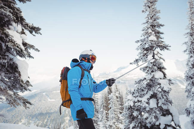 Esqui tomando selfie na montanha coberta de neve — Fotografia de Stock