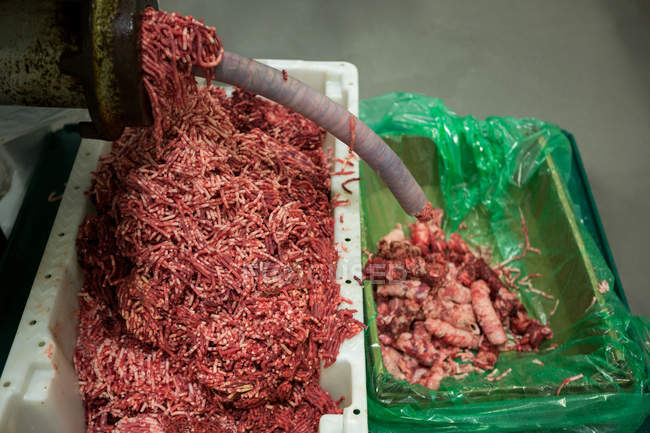 Close-up of meat mincing machine at meat factory — Stock Photo