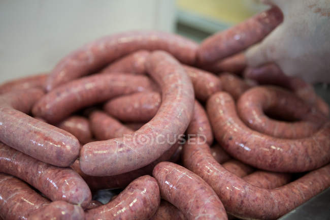 Close-up de salsichas de processamento em fábrica de carne — Fotografia de Stock