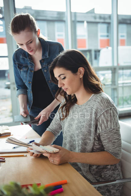 Business executives looking at document in office — Stock Photo