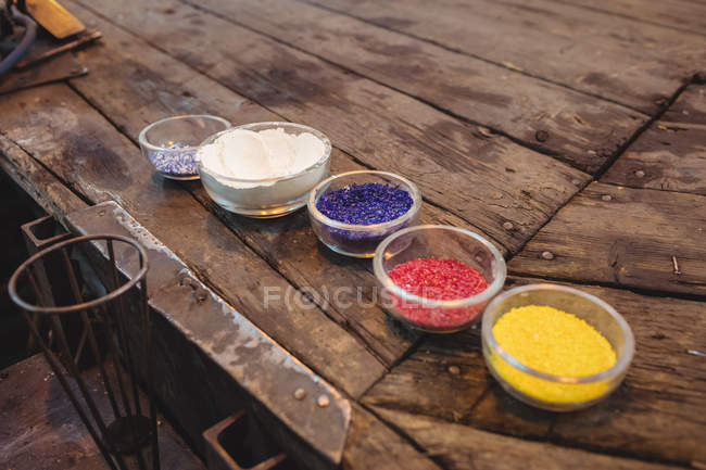 Close-up of frit glass in plastic container at glassblowing factory — Stock Photo