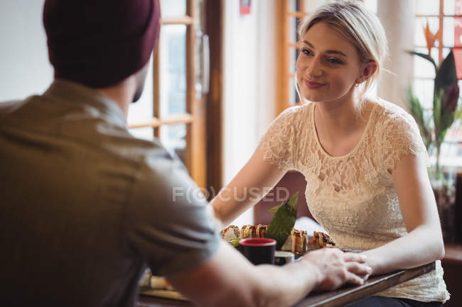 Casal interagindo uns com os outros no restaurante — Fotografia de Stock
