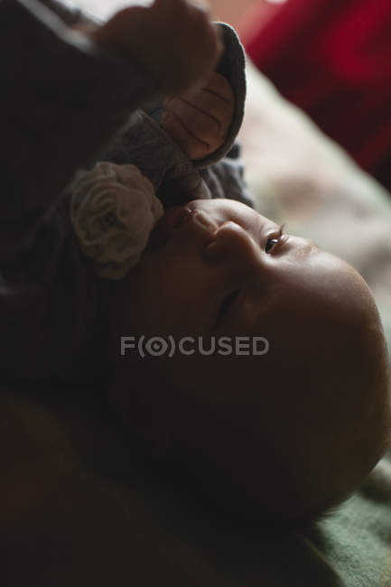 Close-up cute baby lying on bed in bedroom at home — Stock Photo