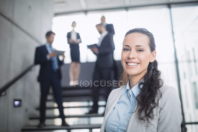 Porträt einer selbstbewussten Geschäftsfrau, die im Amt lächelt — Stockfoto