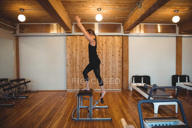 Fit woman practicing pilates in fitness studio — Stock Photo