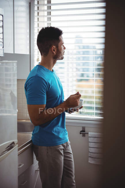 Man having breakfast in the kitchen at home — Stock Photo