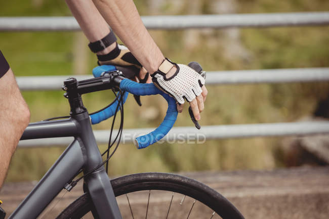 Close-up of athlete riding bicycle on road — Stock Photo