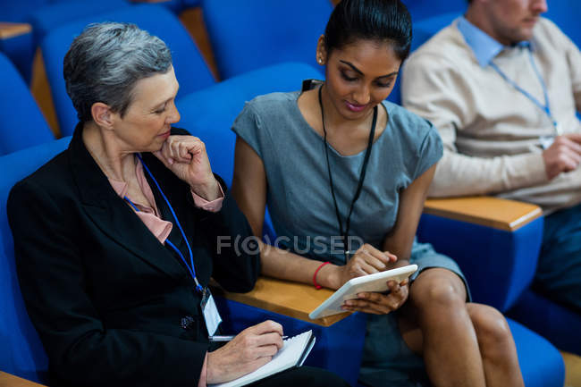 Business executives participating in a business meeting using digital tablet at conference center — Stock Photo