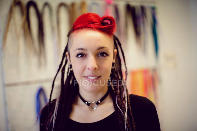 Portrait of female hairdresser in dreadlocks shop — Stock Photo