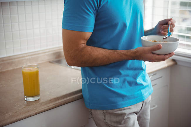 Mezza sezione di uomo che fa colazione in cucina a casa — Foto stock