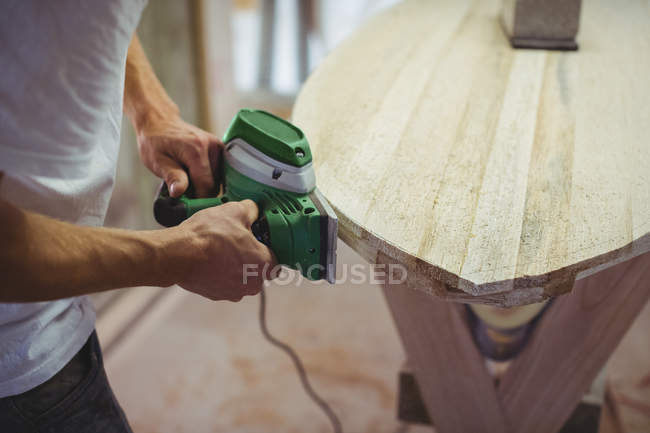 Close-up of man making surfboard in workshop — Stock Photo