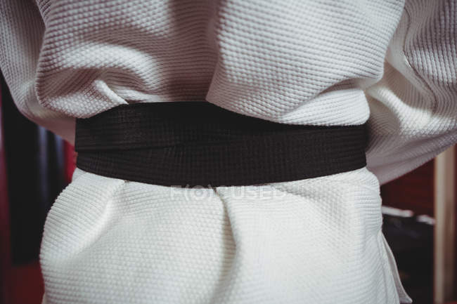 Mid section of karate player in black belt — Stock Photo