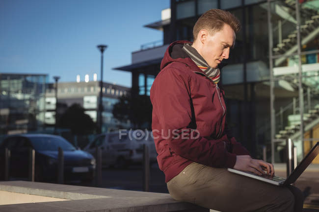 Male executive using laptop in office premise — Stock Photo