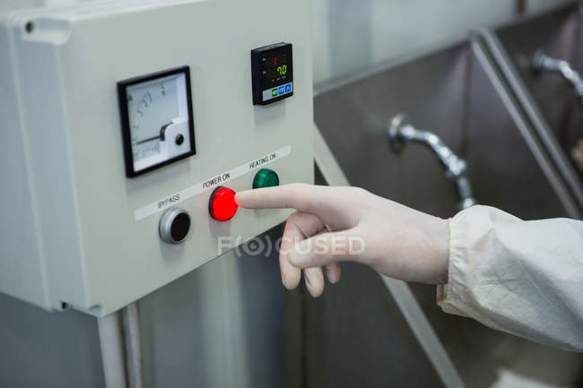 Close-up of technician operating machine at factory — Stock Photo