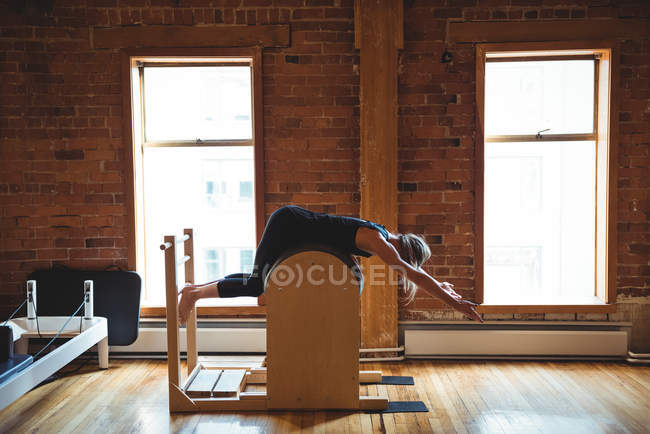 Подходящая женщина занимается пилатесом в фитнес-студии — стоковое фото