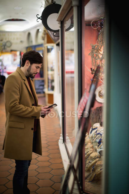 Homem usando tablet digital perto de balcão de jóias no supermercado — Fotografia de Stock