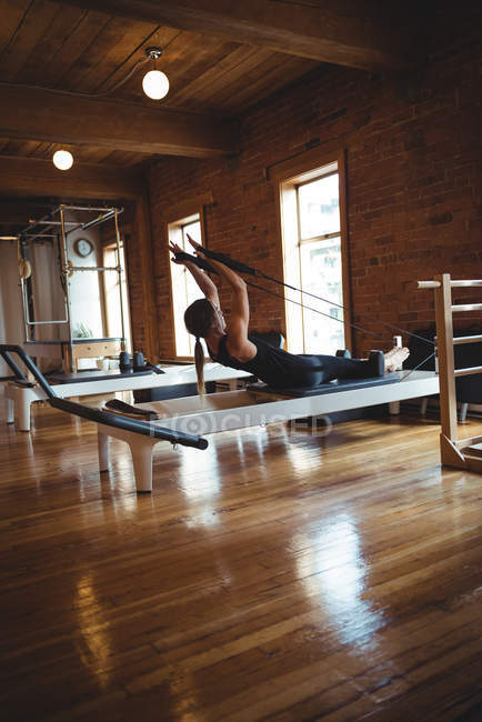 Strong woman practicing pilates in fitness studio — Stock Photo