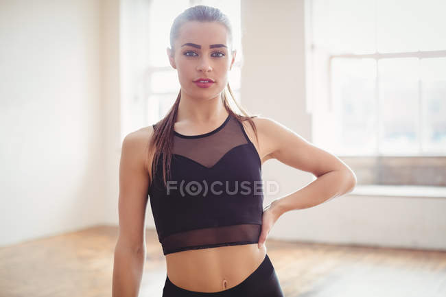 Front view of pretty woman standing in hip hop dance studio — Stock Photo