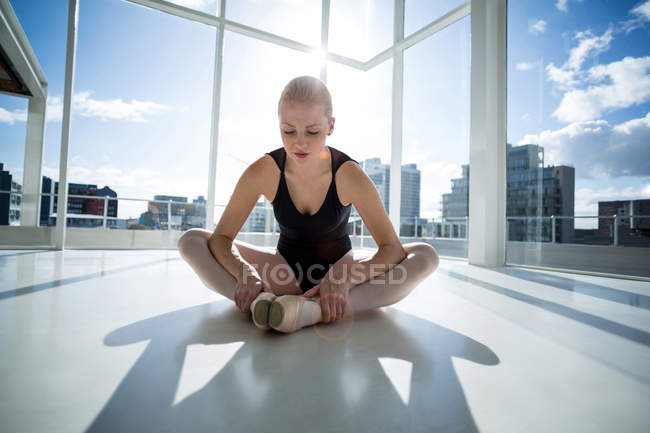 Bailarina realizando un ejercicio de estiramiento en el estudio de ballet - foto de stock