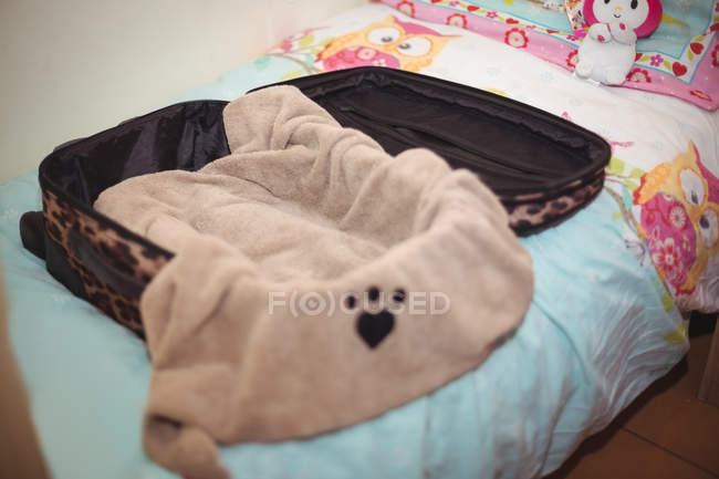 Suitcase with blanket on dog bed at dog care center — Stock Photo