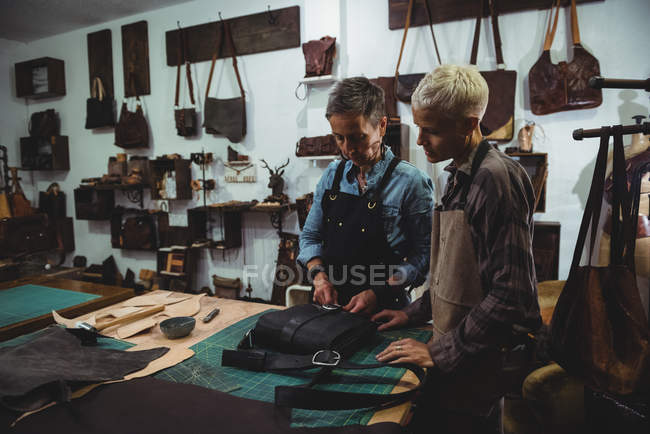 Attentive craftswomen working in workshop interior — Stock Photo