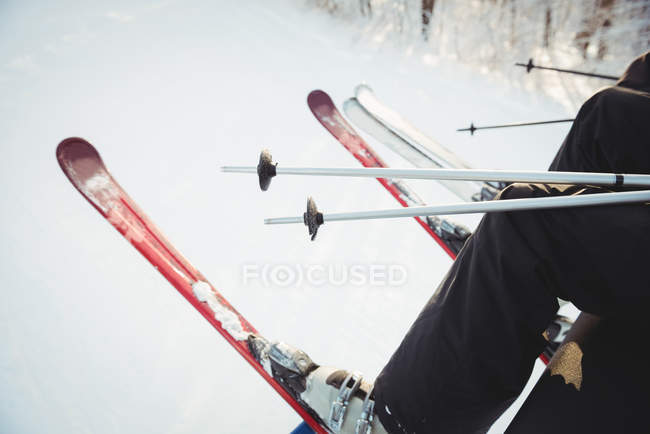 Skier travelling in ski lift during winter — Stock Photo