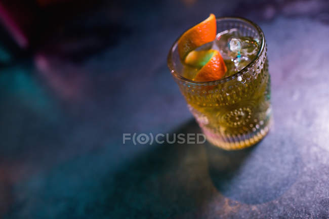 Primer plano del cóctel naranja en vaso en el mostrador en el bar - foto de stock