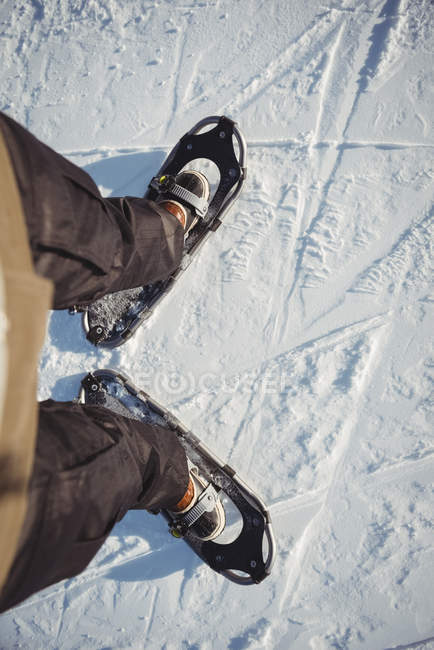 Primer plano de los zapatos de esquiador en la nieve cubierta cuesta abajo - foto de stock