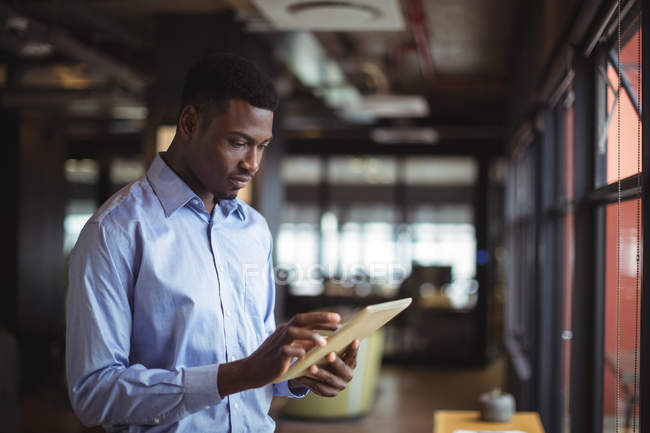 Businessman using digital tablet in office — Stock Photo