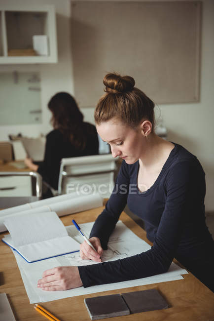 Business executive making a blueprint in office — Stock Photo