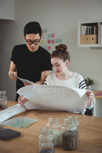 Business executives discussing over blueprint in office — Stock Photo