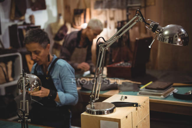 Attentive craftswoman working in workshop interior — Stock Photo