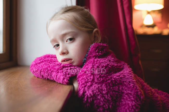 Portrait of cute girl leaning on window sill in bedroom at home — Stock Photo
