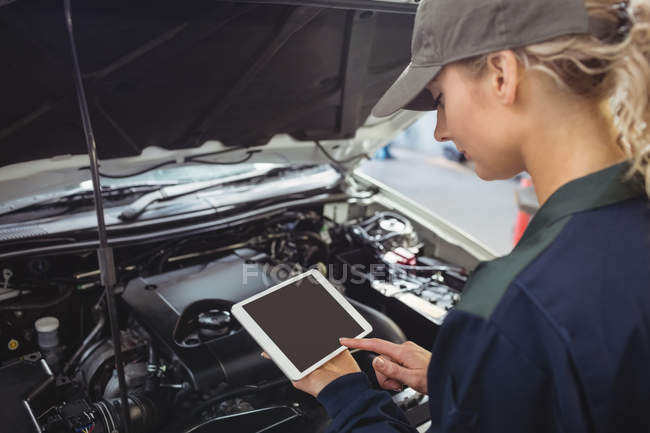 Mechanikerin mit digitalem Tablet in der Werkstatt — Stockfoto