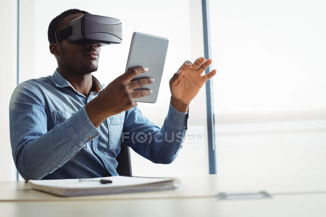 Executivo de negócios usando headset realidade virtual e tablet digital no escritório — Fotografia de Stock
