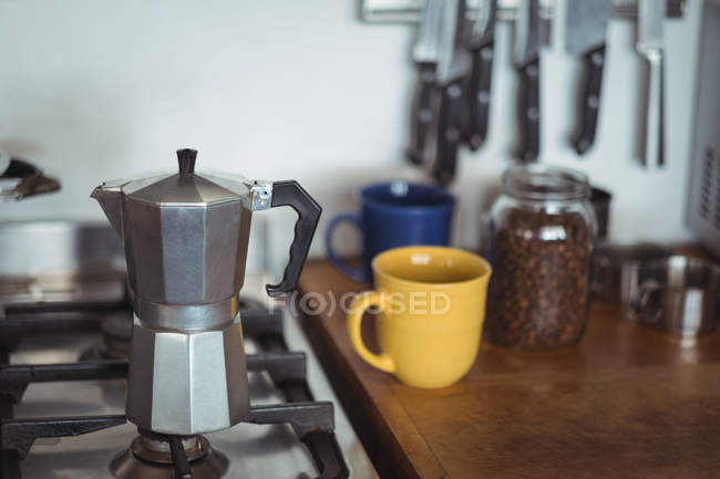 Espresso maker on stove in kitchen — Stock Photo